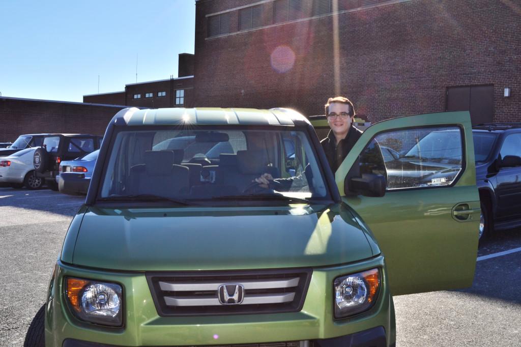 Photo by Chad McCartin
Posing with “The Kiwi,” Christian Parsons (12) shows off his bright green Honda Element. Friends complimented the car for its “space car” features, like a spacious interior, a huge front windshield, and a dashboard that changes colors. 