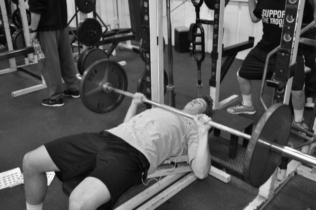 Photo by Chris Adams
Eli Hess (12) lifts weights in preperation of the upcoming lacrosse season. Many athletes started training in early February in hopes of a sucessful season. 