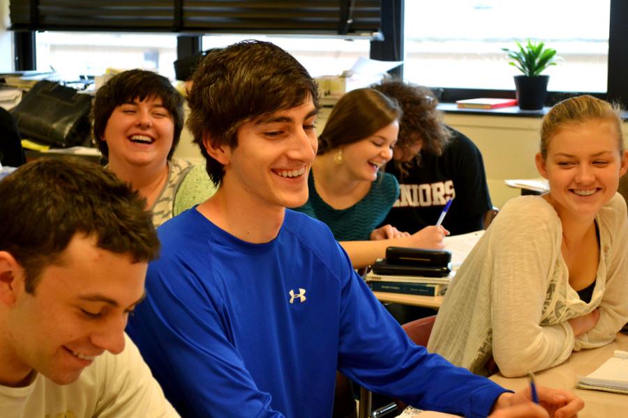 Steven Isett ('15) jokes with students during a Fishbowl Discussion in AP Literature and Composition class.  School-wide, teachers have been employing various discussion strategies in their courses.