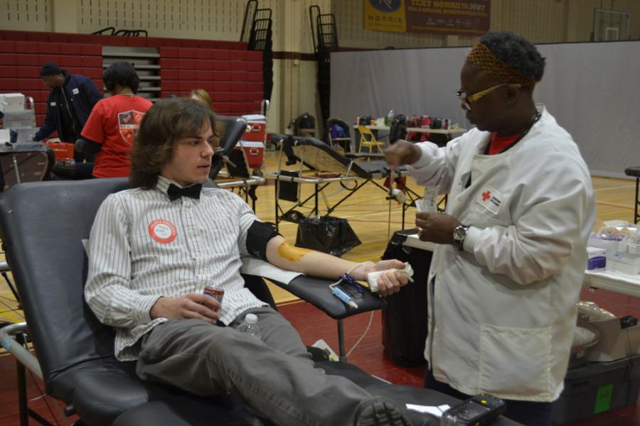 Mike Bailey ('15) donates blood with the Red Cross. Each donation could save up to three lives.