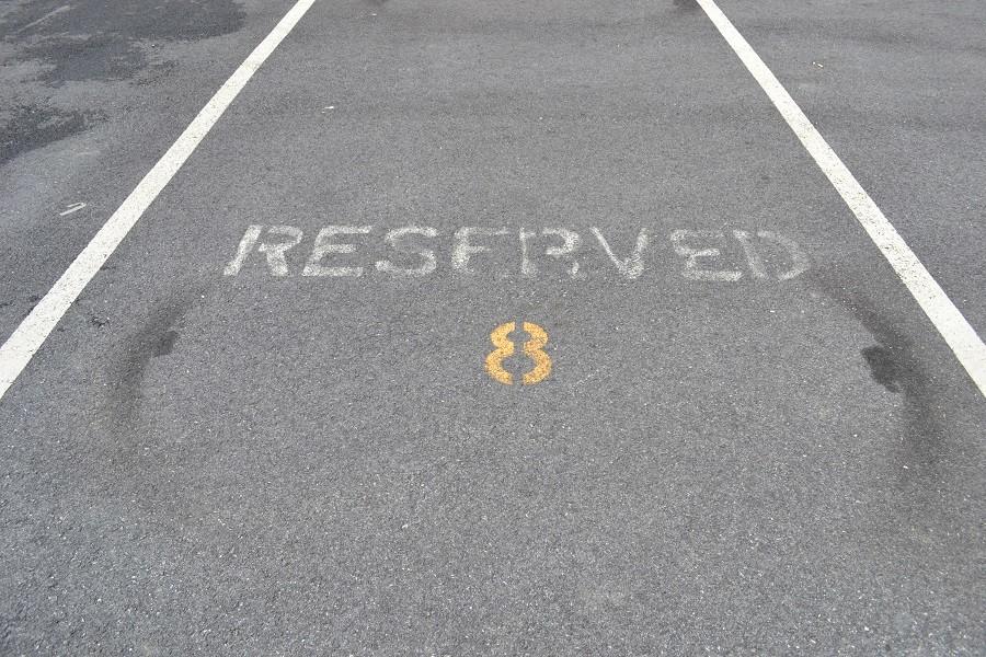 Reserved parking spots are left empty while the student lot is filled. Students felt frustrated when they drove past  unoccupied spots. 