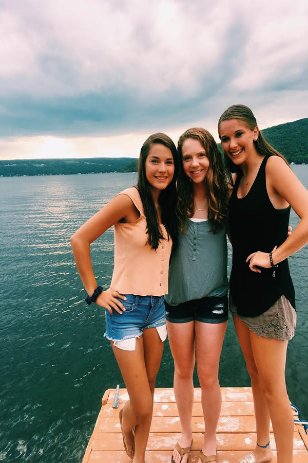Sierra Webb (18), Lily Cavallaro (18), and Anna Jerrems (18) posed on a dock on Keuka Lake. They are on vacation.