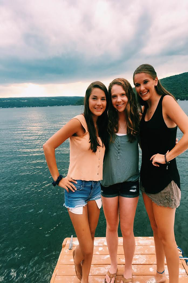 Sierra Webb ('18), Lily Cavallaro ('18), and Anna Jerrems ('18) posed on a dock on Keuka Lake. They are on vacation.