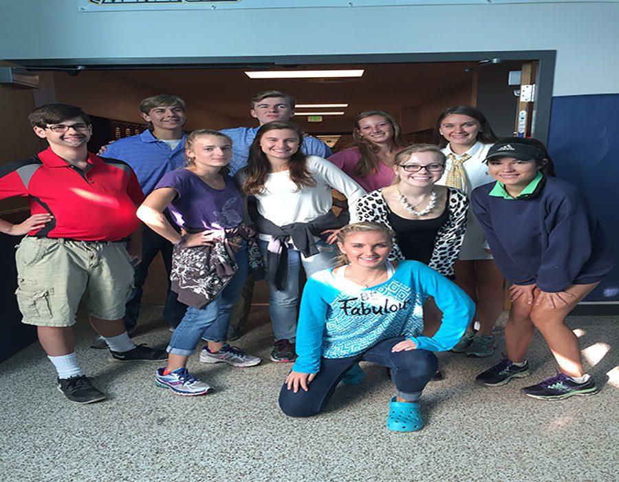 The journalism class poses for a picture.  They were dressed in generation day gear. 