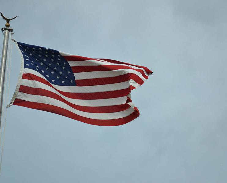 American flags wave in front of national monuments. Our school should take more opportunities to go on field trips to learn more about our history. 