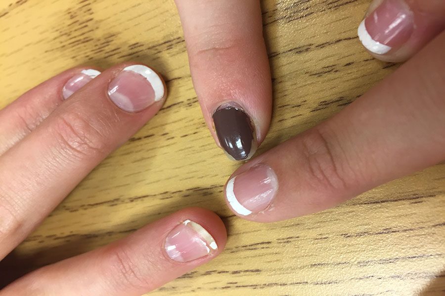 Grace Clarke ('18) Bess Tiller ('18) and Emily McNicholas ('19) all pose with chipped nails one day after the dance. Girls were disappointed in the polish quality. 