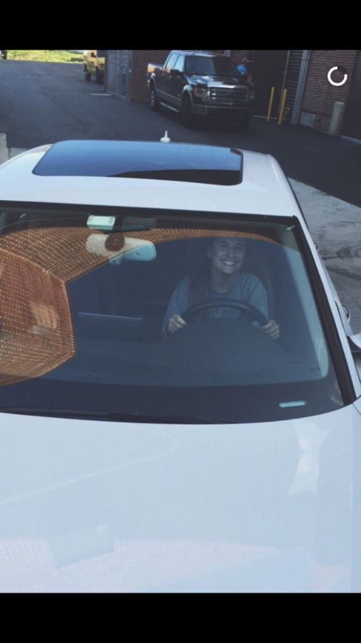 Nicole Burkoski (18) smiles at other drivers on her way to school.