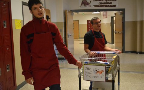 Silas Rock (17) and Jackson (17) push the Bulls Expresso delivery cart through the halls. [The coffee shop] makes working at Hereford even better, Social Studies teacher Robert Greenwood said. For teachers participating in the secret Santa gift exchange, Clark and the Bull Express-O will deliver gifts so teachers can remain anonymous.