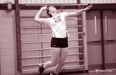 As one of the teams top servers this year, Erin Collins jumps into the air to give a solid serve over the net.