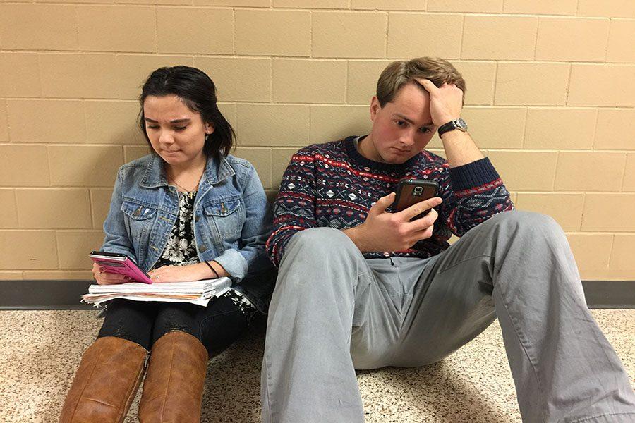 Students are distracted by their phones when completeing schoolwork. Caitlynn Hickey ('17) and Tony Cabral ('17) were very stressed out.