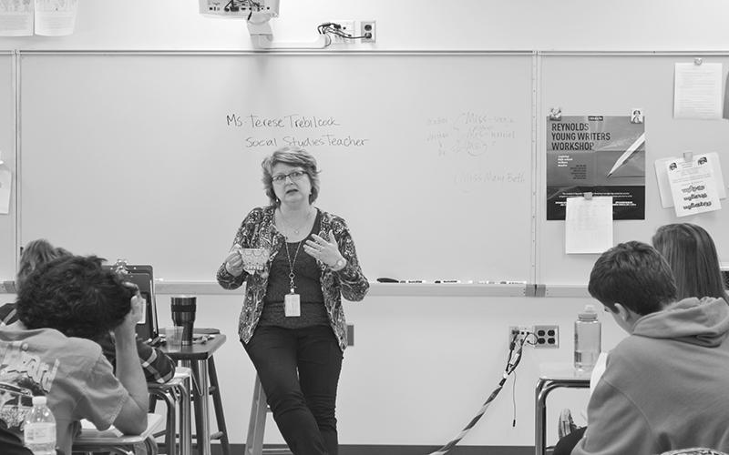 Social Studies teacher Terese Trebilcock answers journalism students' questions during a moch press conference. "Teaching is much more exciting and unpredictable than any other job I've had," Trebilcock said.
