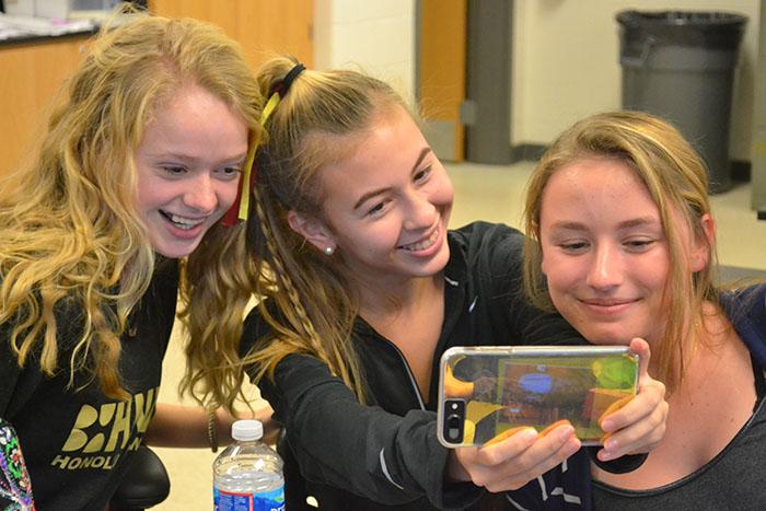 Abby Walters ('19), Lily Robertson ('19), and Lynzie Ritz ('19) take selfies instead of studying during enrichment. Robertson sent the photo to friends through Snapchat. 