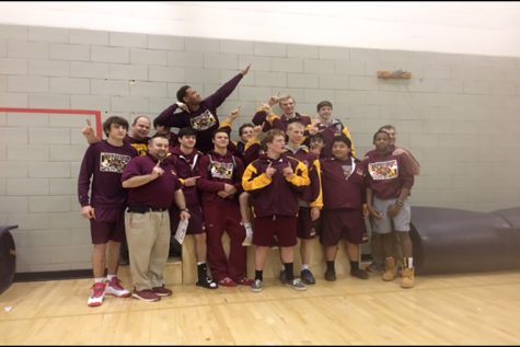 The varsity wrestling team poses for a picture after Regionals.  They competed in the tournament earlier that day.