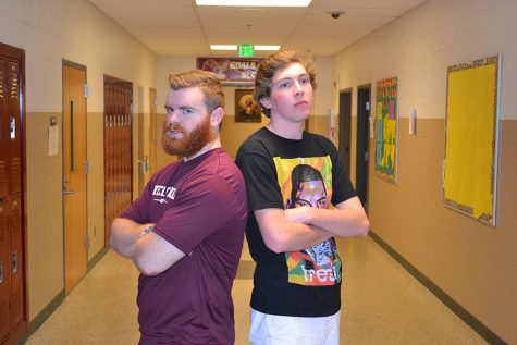 Martin and Lory stand back to back while posing for a picture. They competed against each other in the first Senior vs Teacher Basketball Game.