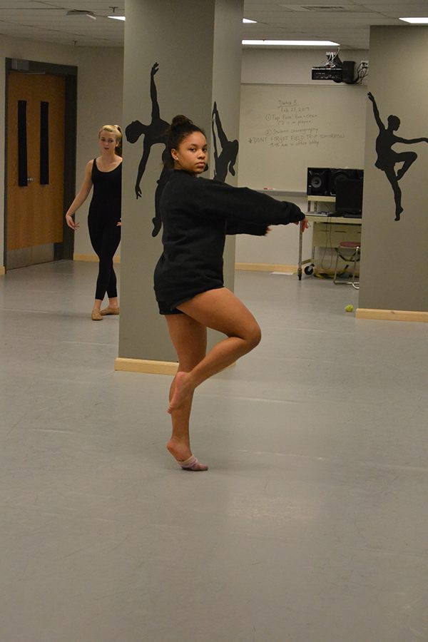 Nya Bennett (19) warms up in the beginning of class.