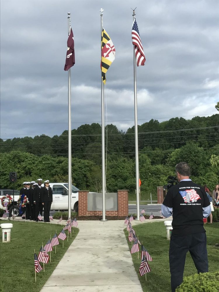 The Hereford and Woodlawn Chamber Choir sing the National Anthem as ROTC members raise the flag.