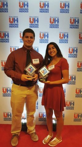 Kelbaugh and Faridi hold their awards. They both were recognized as team unsung heroes.