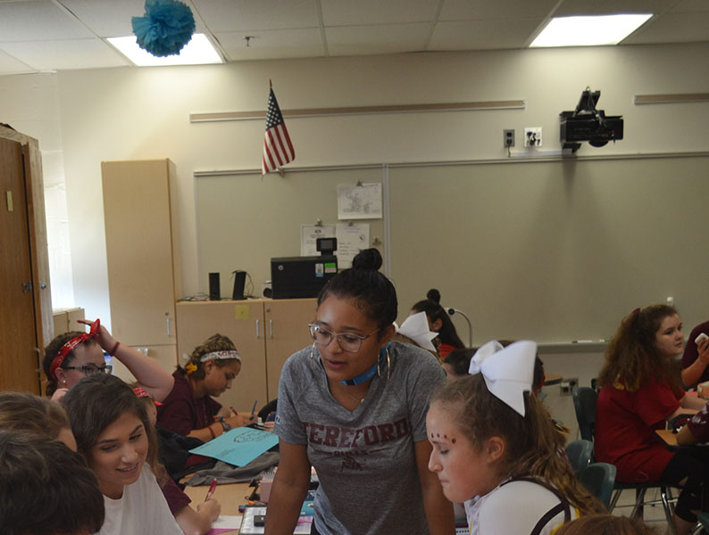 Ms. Espeut helps Carissa Mileto (20) with her work. Students were studying social development of children ages 3-5. 