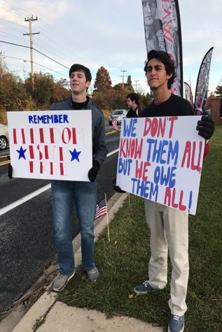 For our troops club members hold up colorful signs in front of the school this morning.