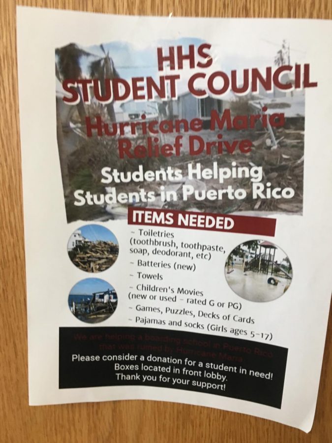 Posters with information for the relief drive indicate needed items and are located throughout the building.