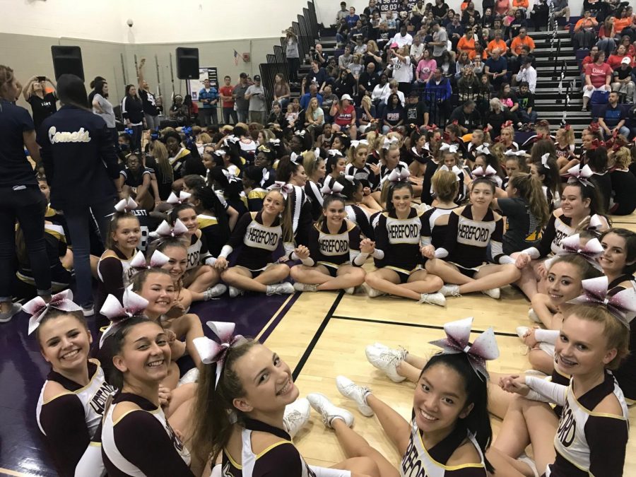 JV+cheer+squad+circles+up+awaiting+awards+after+their+first+invitational.