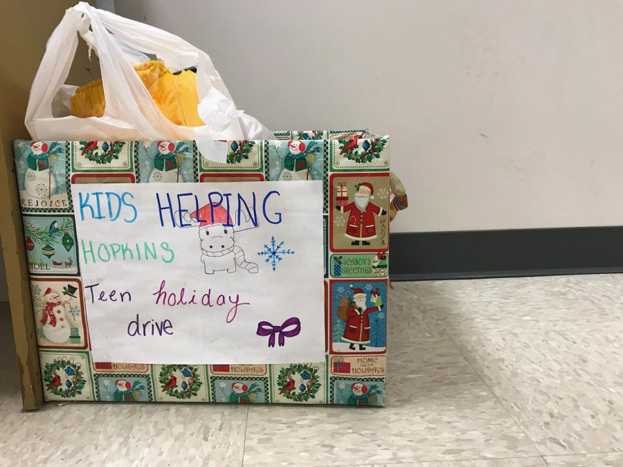 The collection box  is filled with toys and clothes . Kids Helping Hopkins held a drive to collect items to donate to patients at Johns Hopkins Children's Center.