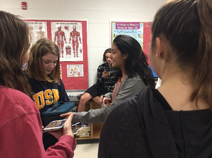 Emma Swensen (20) celebrates the end of the House of Ruth drives during the Team One Loves holiday party. She donated toothbrushes, toothpaste, bar soap, and deodorant to help the cause.