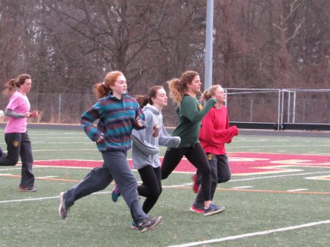 Girls track team warms up before practice. The team recently won the Warrior Invitational, as well as other meets.