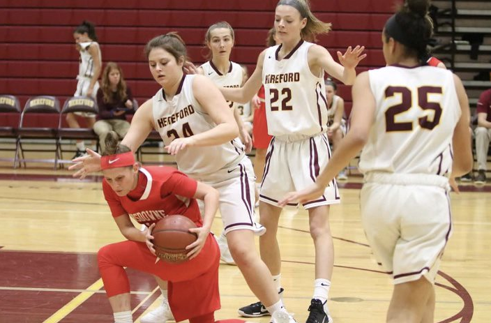 Cam Smith (19), Lindsay Clarke (20), and Brynne DeLuzio (19) compete against Landsdowne High School.  The hard-fought game ended in a win for Hereford.