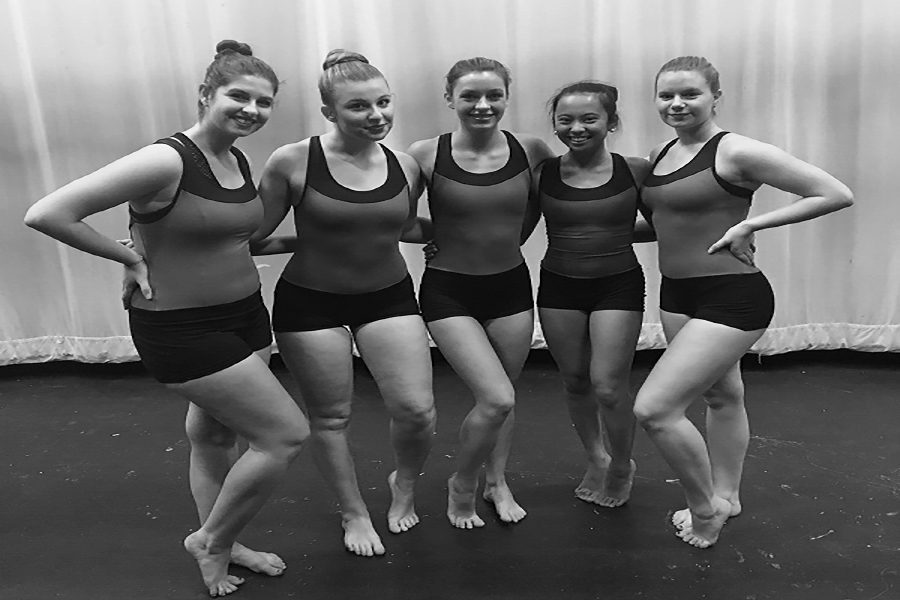 Megan Loomis ('18), Lily Albanese ('18), Gillian Tiralla ('18), Katrina Villanueva ('18), and Grace Isennock ('18) pose for a picture before their last winter performance. They will be performing on April 12 in their last ever high school performance. 