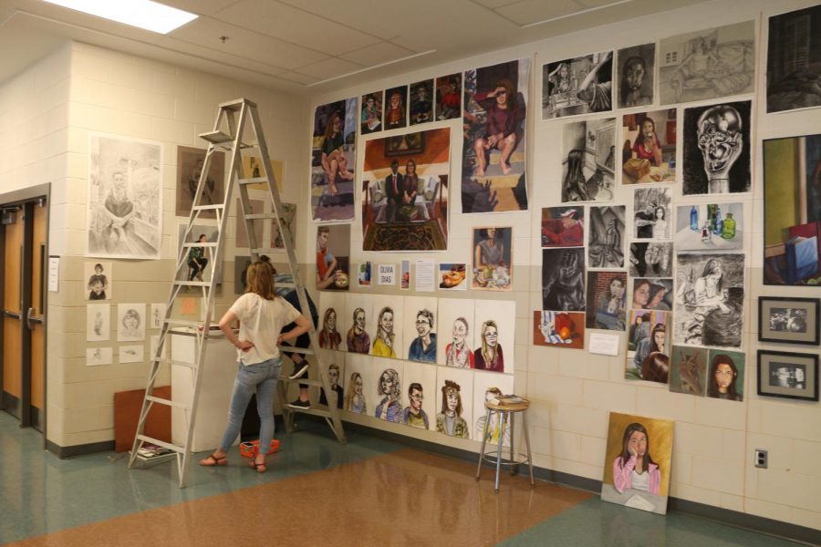 Hereford graduates set up their displays for the annual art show in the caffeteria. The AP Studio students showed off their portfolios to guests.
