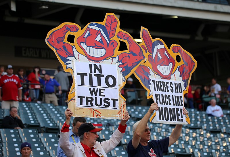 	Diehard Cleveland Indians fans brandish their posters, sporting a muscular version of Chief Wahoo. The Indians made the decision, along with some encouragement from the MLB, to remove the logo after the 2018 season. 