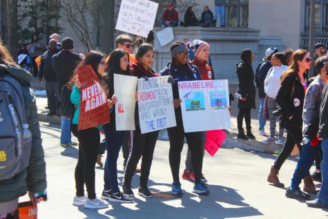 Students pose with anti-gun violence signs, urging lawmakers to protect citizens. The march signified unity of students across the country. 