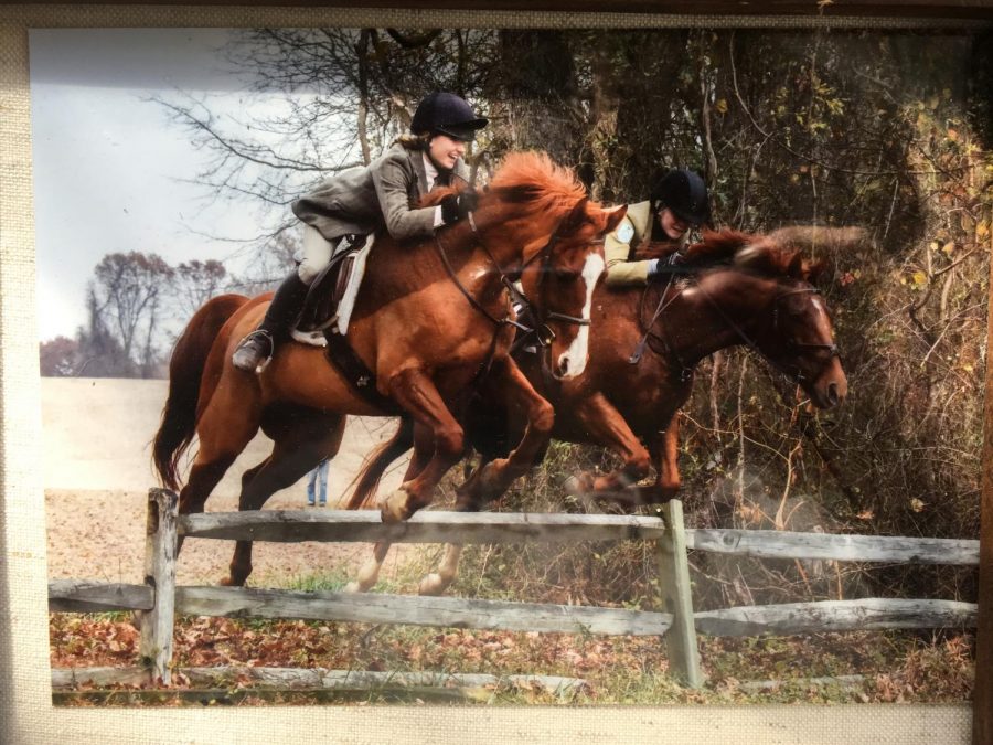 Hannah O'Brien ('19) jumps a fence while fox hunting with Mount Caramel Hunt Club.  She started fox hunting before she started show jumping. 