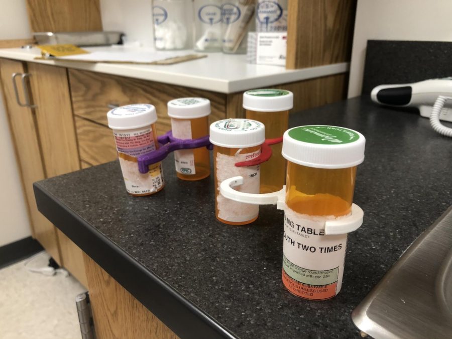 Nurse Perry uses pill bottle holders in her office. Engineering students made them to  solve the organization problem. some students have who take multiple prescriptions at school.