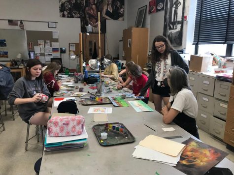 Joanne Bare assists a student with her work. Many of her former students pursued art in college.