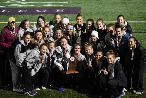 The girls field hockey poses with their second place trophy. The team was defeated 1-0 to Liberty, after winning the County and Regional Championships.