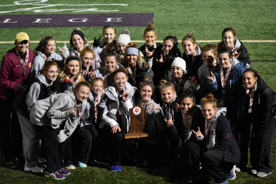 The girls' field hockey poses with their second place trophy. The team was defeated 1-0 to Liberty, after winning the County and Regional Championships.