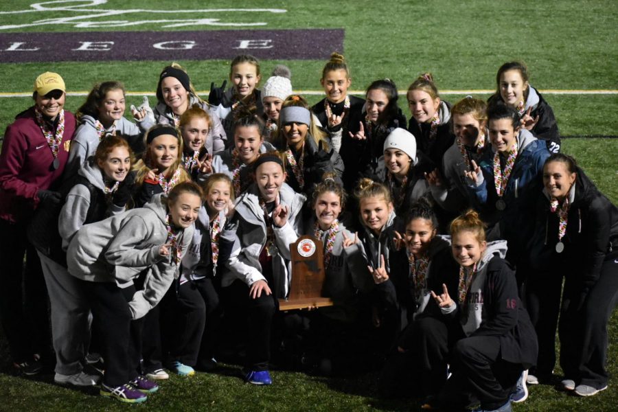 The+girls+field+hockey+poses+with+their+second+place+trophy.+The+team+was+defeated+1-0+to+Liberty%2C+after+winning+the+County+and+Regional+Championships.