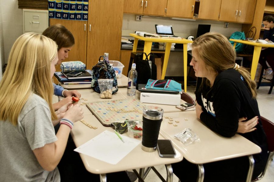Courtney Craig ('22), Kayla Nieberlein ('22), and Piper Lentz ('22) play a game of Scrabble during one NEHS Monday in Mrs. Vance's room. Members were asked to invite other students to the event to play.