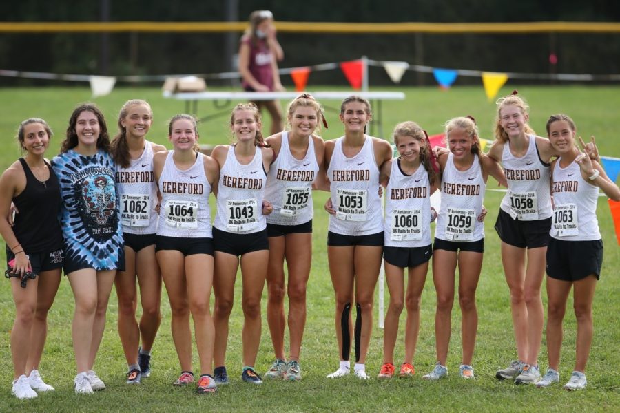 Members of the Lady Bulls’ cross-country team pose for a race day photo. The team placed second in the Female Elite division.
