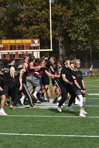 Mac Tiller (22) leads on-field celebrations after the final whistle. Tiller served as one of the seniors key facilitators. 