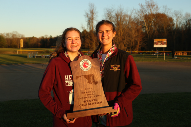 Megan Warrenfeltz (’23) and Piper Lentz (’22) pose with the state championship trophy. Both were key contributors to the team during the entire season.
