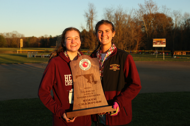 Megan+Warrenfeltz+%28%E2%80%9923%29+and+Piper+Lentz+%28%E2%80%9922%29+pose+with+the+state+championship+trophy.+Both+were+key+contributors+to+the+team+during+the+entire+season.