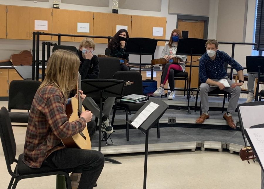 Students in Mr. Sobel's intermediate and advanced guitar classes listening to senior Ben Pfitzinger play a solo piece. 