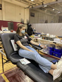 Megan Rodgers (‘22) squeezes her hand as she gives blood. Masks were also a requirement for all people in the facility, for the safety of everyone. 