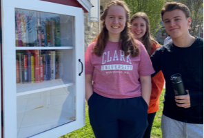 Students Amelia Clark (’22), Grace Wagaman (‘22) and Jack Bennett (’22) pose after stocking the Little Free Library with books.