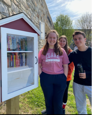 Students Amelia Clark (’22), Grace Wagaman (‘22) and Jack Bennett (’22) pose after stocking the Little Free Library with books.