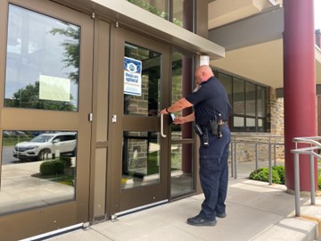 Officer Croft swipes his key card to enter the front doors of the building. In his office, Croft kept an eye on the hallways and entrances around the school.