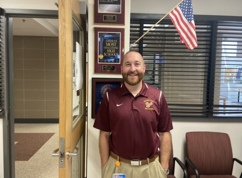 Principal Covert proudly shows off Hereford's many awards.